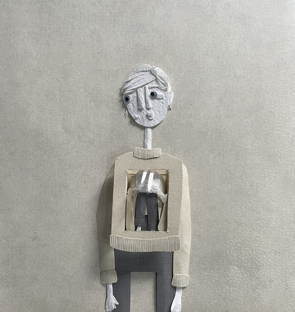 A papercut collage in shades of grey. The collage is of a thin, androgynous figure, looking worried. They're wearing a sweater and jeans.