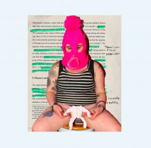 chubby tattooed figure dressed in a pink bobble hat balaclava head covering and a striped sleeveless top sitting upon a toilet holding a seemingly headless baby doll with teeth sewn into its torso between their legs, upon a background of a research paper and handwritten notes
