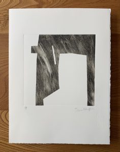 Image shows abstract shape in black ink with multiple fine marks interrupting the surface and large sections of white paper left blank.