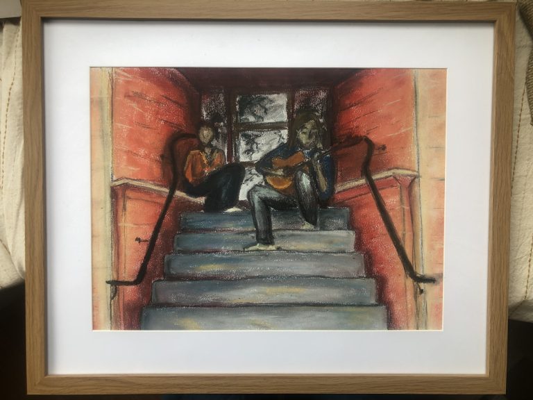 Framed drawing in soft pastels of two people sitting on a flight of steps at the entrance to an apartment building. The walls either side are a reddish brick colour and the steps are grey. The man sits on the top step on the right hand side, playing a guitar. The woman sits on the left hand side, slightly further back from the audience. The colours are warm and there is a dreamy, unfocused quality.