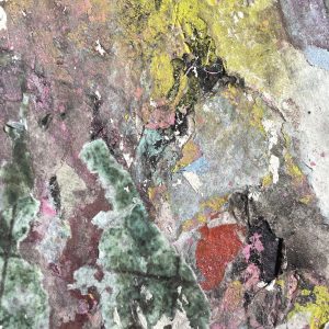 Close-up view of textured and colourful paper layers with lots of varying textures.