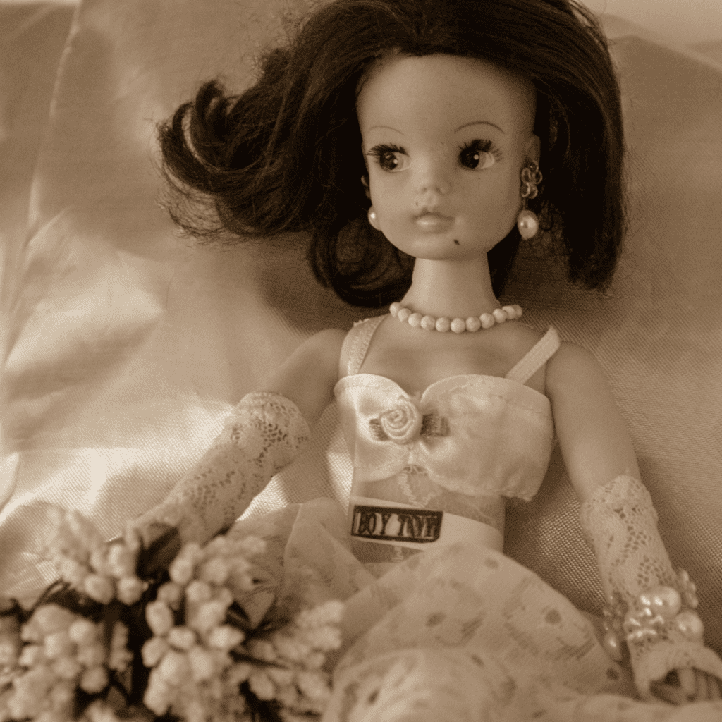 A Sindy Doll, made up and posed in a glamorous way. The photograph has a vintage style filter.