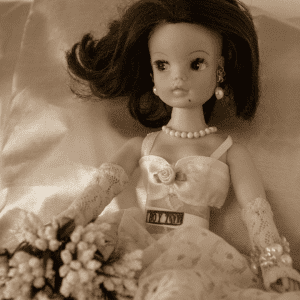 A Sindy Doll, made up and posed in a glamorous way. The photograph has a vintage style filter.