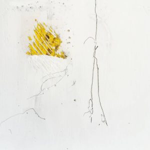 A small square made of concrete and plaster with some marks made on it, it is mostly white but there is some yellow coming though from underneath at one part.