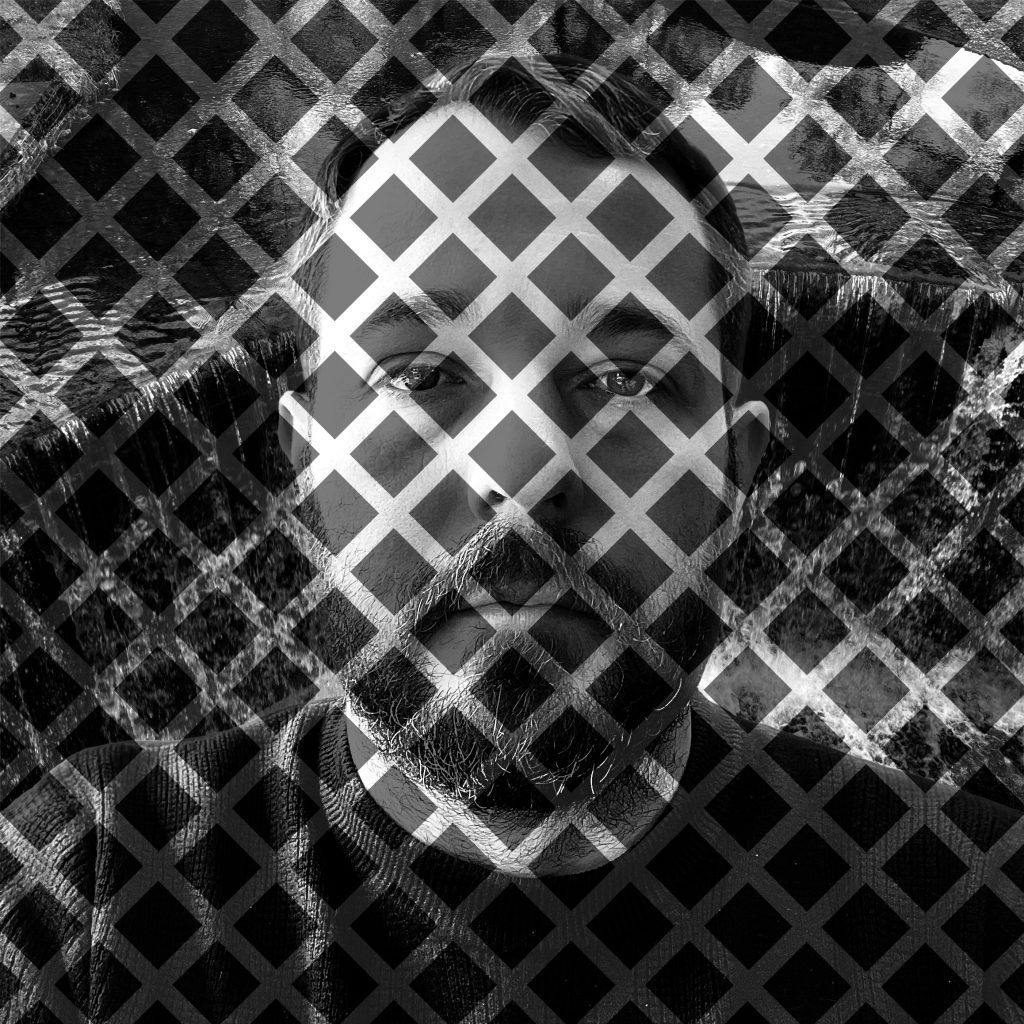 Back and white portrait of a white man's head and shoulders, overlaid with a diagonal grid-like pattern.