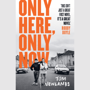 A book cover featuring a black and white photograph of a brother and sister around the age of 12, standing in the street in a Scottish town. Overlaid in a bold orange font is the title, Only Here, Only Now.