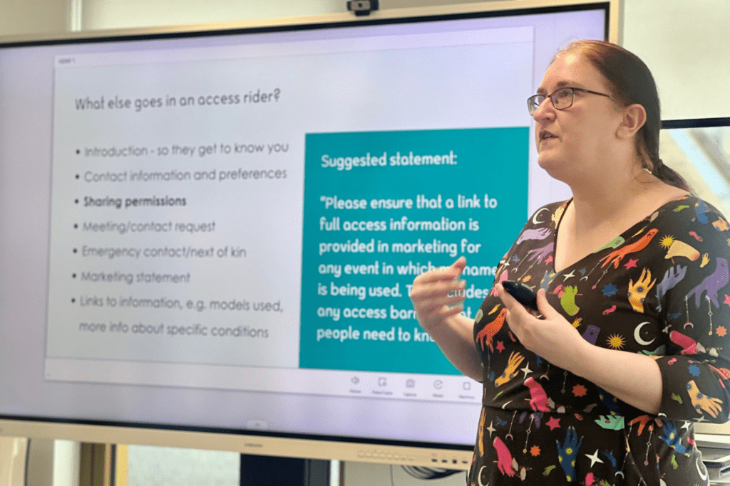 A woman giving a presentation in front of a large screen