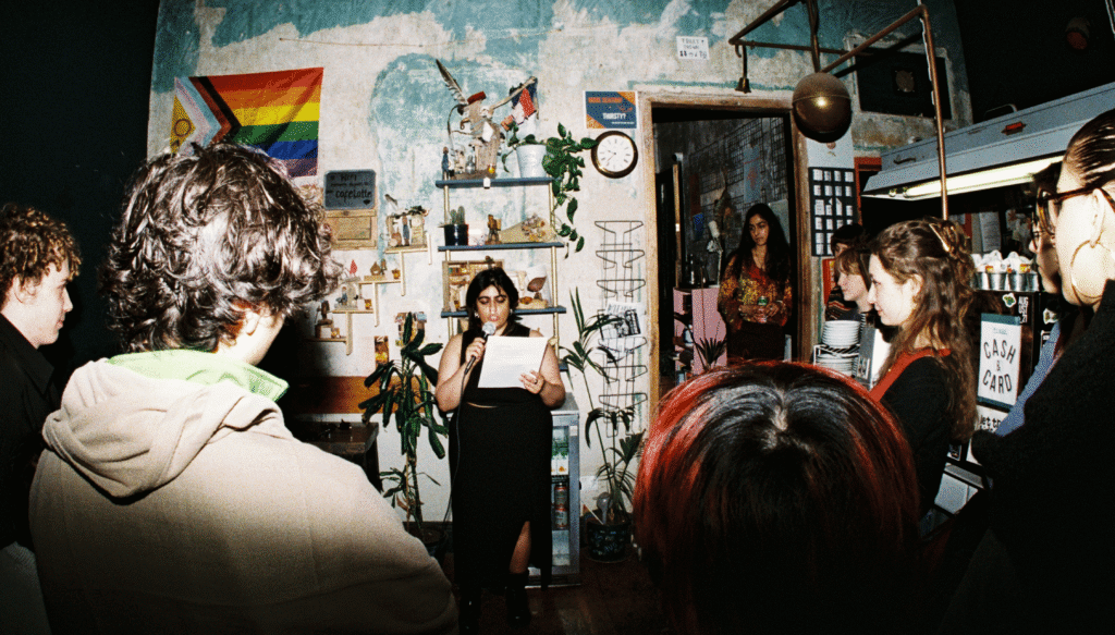 Nyla Noor performing poetry and storytelling at Chromatopia Zine Launch in August 21 Cafe in Edinburgh.