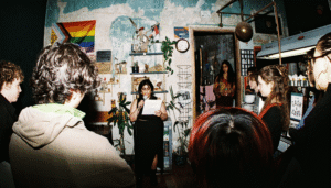 Nyla Noor performing poetry and storytelling at Chromatopia Zine Launch in August 21 Cafe in Edinburgh.